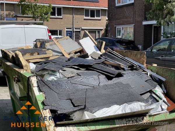 Afvalcontainer met gesloopt dakmateriaal tijdens dakkapel renovatie in Huissen