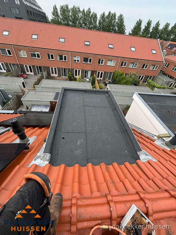 Bitumen dak reparatie op plat dak tussen dakpannen in Huissen