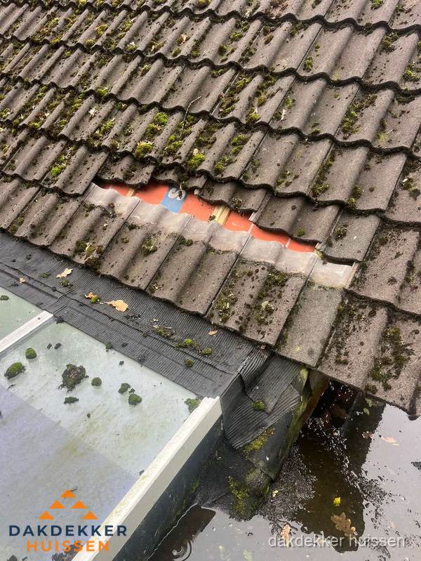 Beschadigd pannendak met ontbrekende dakpannen voor reparatie in Huissen