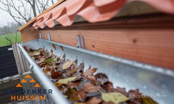 Dakgoot vol bladeren die gereinigd moet worden in Huissen